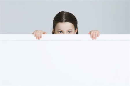 simsearch:632-01193783,k - Little girl peeking over ledge at camera Stock Photo - Premium Royalty-Free, Code: 695-03380564