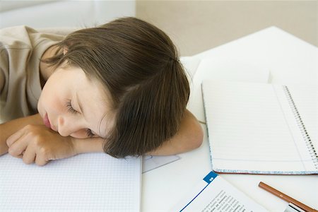 simsearch:614-07031850,k - Boy sitting with homework, head resting on arm, eyes closed Stock Photo - Premium Royalty-Free, Code: 695-03380615
