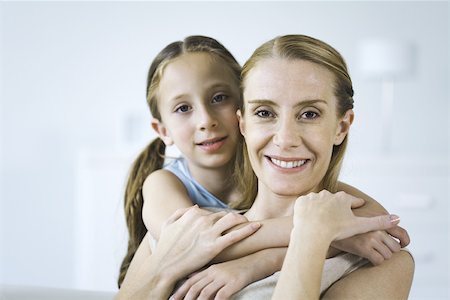 simsearch:632-05816381,k - Mother and daughter embracing, both smiling at camera Stock Photo - Premium Royalty-Free, Code: 695-03380708