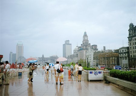 China, Shanghai, The Bund, people on sidewalk holding umbrellas Stock Photo - Premium Royalty-Free, Code: 695-03381974