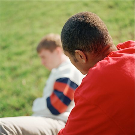 simsearch:695-03382482,k - Two young men, one sitting on grass Stock Photo - Premium Royalty-Free, Code: 695-03382473