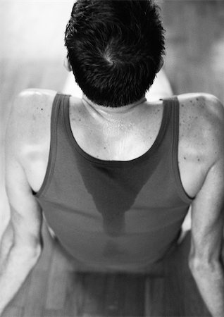 simsearch:689-03131217,k - Man sitting on floor, wearing sweaty tanktop, high angle rear view, black and white. Stock Photo - Premium Royalty-Free, Code: 695-03382679