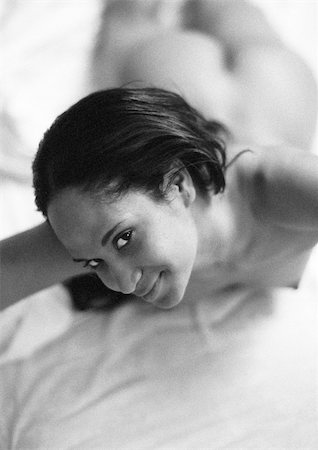 simsearch:695-03382717,k - Nude woman lying on bed, looking up at camera, black and white. Stock Photo - Premium Royalty-Free, Code: 695-03382736