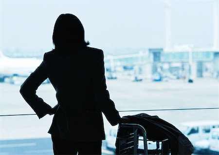 shadow plane - Businesswoman next to luggage, silhouette, airplanes in background Stock Photo - Premium Royalty-Free, Code: 695-03382794