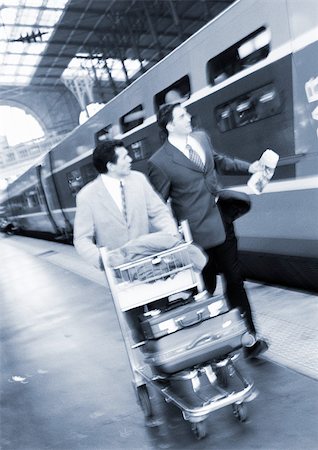 simsearch:695-05773315,k - Businessmen walking next to train on platform, b&w. Stock Photo - Premium Royalty-Free, Code: 695-03382899