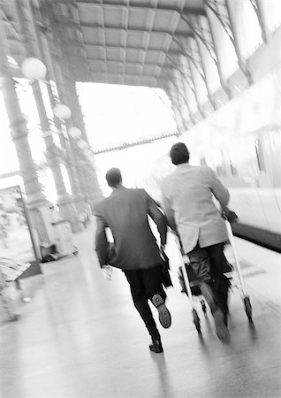 simsearch:695-05773315,k - Businessmen hurrying on train platform, blurred, rear view. Stock Photo - Premium Royalty-Free, Code: 695-03382901