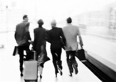 simsearch:695-03386286,k - Group of business people hurrying on train platform, rear view, blurred, b&w. Stock Photo - Premium Royalty-Free, Code: 695-03382944