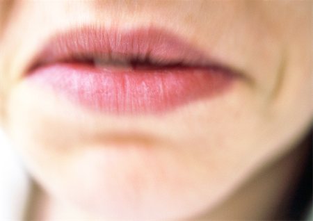 Close up of woman's mouth frowning, blurry. Stock Photo - Premium Royalty-Free, Code: 695-03383247