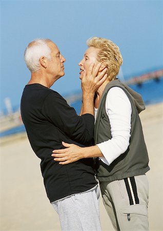 simsearch:614-06897731,k - Mature couple standing on beach, embracing, side view Stock Photo - Premium Royalty-Free, Code: 695-03383696