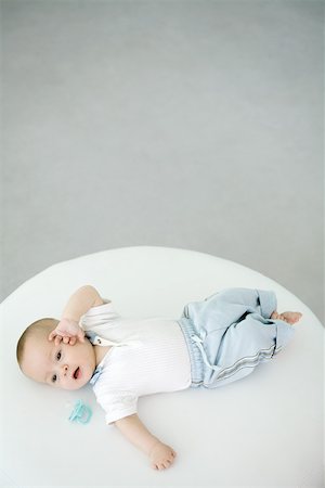 simsearch:632-03027302,k - Baby lying beside pacifier, overhead view Stock Photo - Premium Royalty-Free, Code: 695-03390065