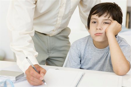 simsearch:695-03380694,k - Father helping son with homework, boy holding head and looking away, cropped view Stock Photo - Premium Royalty-Free, Code: 695-03390111