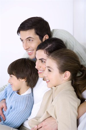 simsearch:695-05769087,k - Man embracing his wife and children, all looking away and smiling Stock Photo - Premium Royalty-Free, Code: 695-03390389