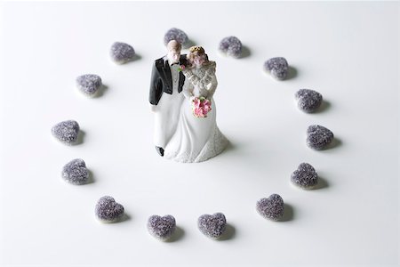 Miniature bride and groom surrounded by candy hearts Stock Photo - Premium Royalty-Free, Code: 695-03390444