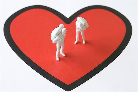 shape toys - Miniature figures standing on large heart Stock Photo - Premium Royalty-Free, Code: 695-03390447