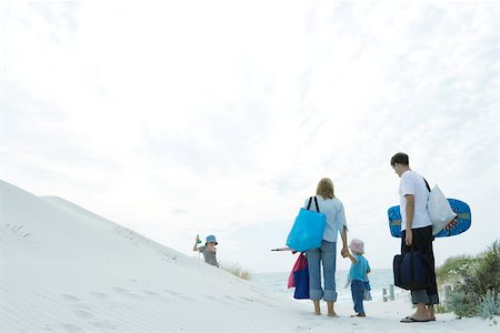 Family walking through dunes to beach Stock Photo - Premium Royalty-Free, Code: 696-03394014