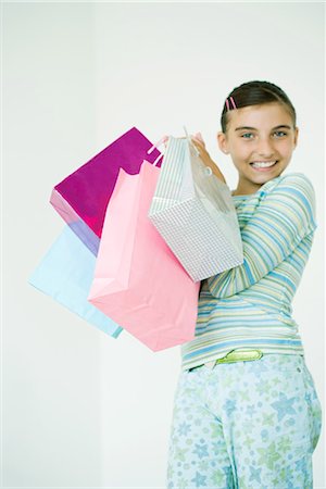 simsearch:696-03394065,k - Girl holding up shopping bags Foto de stock - Sin royalties Premium, Código: 696-03394061