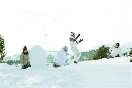 simsearch:400-05381058,k - Young friends throwing snowballs at each other, full length Stock Photo - Premium Royalty-Free, Code: 696-03394352