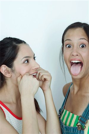 Two young female friends making faces, portrait Stock Photo - Premium Royalty-Free, Code: 696-03394628