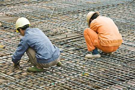 Construction workers working at construction site Stock Photo - Premium Royalty-Free, Code: 696-03395167