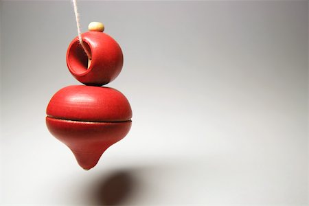 simsearch:614-06336098,k - Spinning top hanging on string, close-up Stock Photo - Premium Royalty-Free, Code: 696-03395604