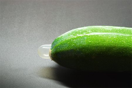 Condom on zucchini, close-up Stock Photo - Premium Royalty-Free, Code: 696-03395687