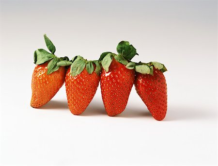 simsearch:6118-07354031,k - Four strawberries in a row Stock Photo - Premium Royalty-Free, Code: 696-03395760