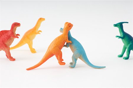 dinosaur - Toy dinosaurs fighting while others watch Stock Photo - Premium Royalty-Free, Code: 696-03395946