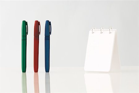 simsearch:6118-07354031,k - Colorful pens upright on table, notebook Stock Photo - Premium Royalty-Free, Code: 696-03395960