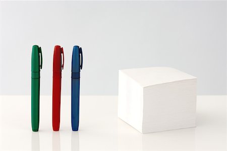 simsearch:6118-07354031,k - Stack of adhesive notes, multicolored pens standing in a row nearby Stock Photo - Premium Royalty-Free, Code: 696-03396021