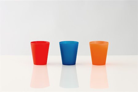 Three cups lined up in a row, multicolored Stock Photo - Premium Royalty-Free, Code: 696-03396023