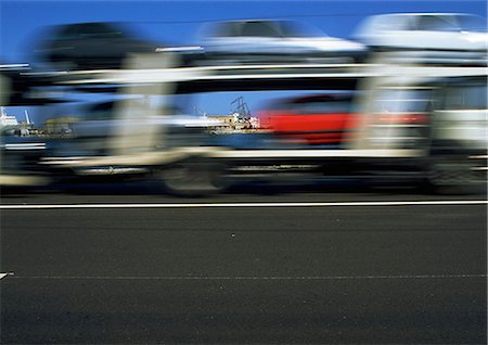 semi car transporter - Truck carrying cars, blurred motion Stock Photo - Premium Royalty-Free, Code: 696-03396283