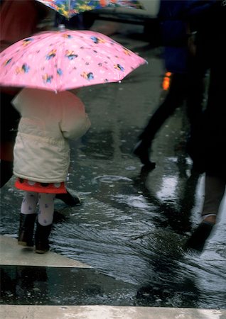 puddle in the rain - People walking in rain Stock Photo - Premium Royalty-Free, Code: 696-03396874
