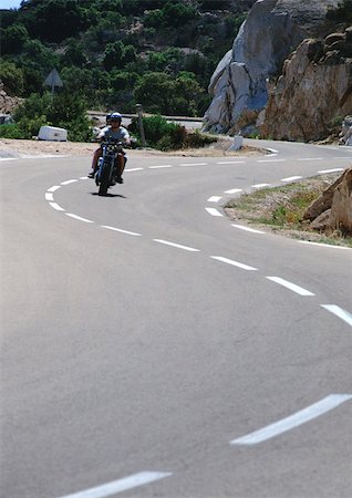 Motorcycle on winding road Stock Photo - Premium Royalty-Free, Code: 696-03397516