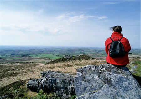 simsearch:632-05759883,k - France, Brittany, hiker sitting on rock, looking out over landscape, rear view Stock Photo - Premium Royalty-Free, Code: 696-03398045
