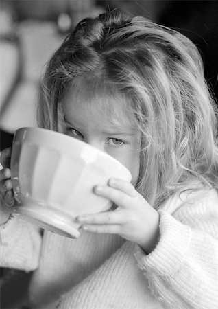 Little girl drinking from bowl, b&w Stock Photo - Premium Royalty-Free, Code: 696-03398656