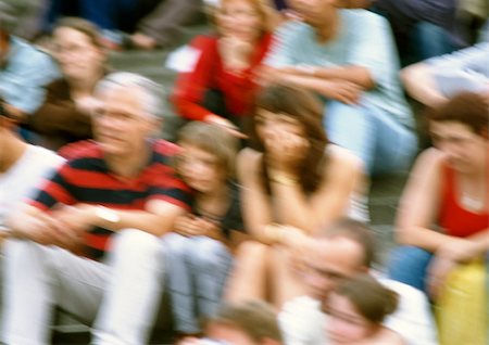 Corwd of people sitting on steps, blurred Stock Photo - Premium Royalty-Free, Code: 696-03399403