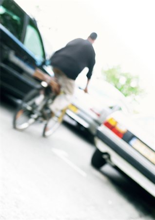 people in traffic jam - Cyclist and cars, tilted, blurred Stock Photo - Premium Royalty-Free, Code: 696-03399640