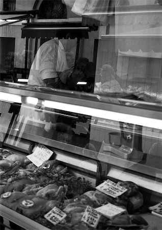 Butcher behind counter, b&w Stock Photo - Premium Royalty-Free, Code: 696-03399930