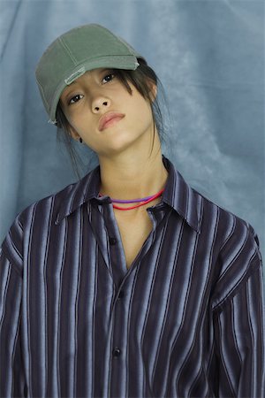 Adolescente portant le grand bouton bas chemise et casquette de baseball, portrait Photographie de stock - Premium Libres de Droits, Code: 696-03393954