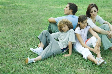 simsearch:614-06043612,k - Family outdoors, sitting on grass back to back Stock Photo - Premium Royalty-Free, Code: 696-03393967
