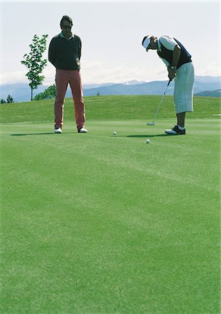 simsearch:6113-07159316,k - Golfers putting Stock Photo - Premium Royalty-Free, Code: 696-03400055