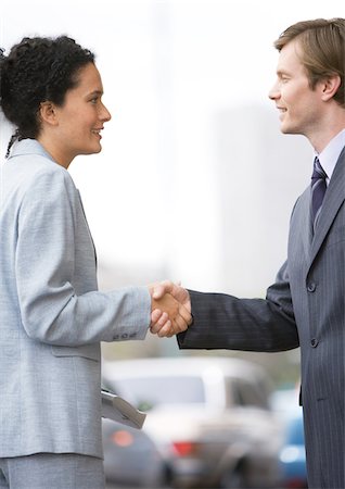 simsearch:640-03262464,k - Businesswoman and man shaking hands Stock Photo - Premium Royalty-Free, Code: 696-03400217