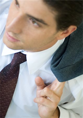 Businessman holding coat over shoulder Stock Photo - Premium Royalty-Free, Code: 696-03400222