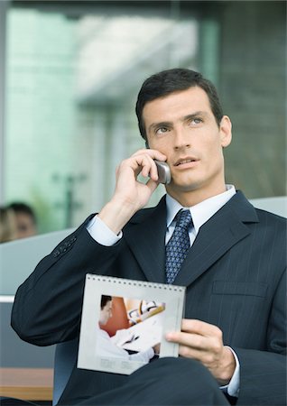 simsearch:632-03403433,k - Man talking on phone and holding calendar Stock Photo - Premium Royalty-Free, Code: 696-03400237