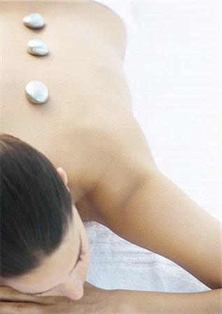 Woman with hot stones on back Stock Photo - Premium Royalty-Free, Code: 696-03400317