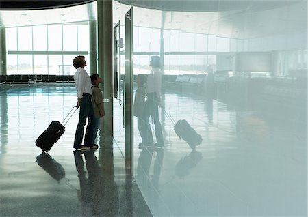 Woman and boy standing in airport concourse Stock Photo - Premium Royalty-Free, Code: 696-03400965