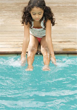 simsearch:632-01193783,k - Girl sitting on edge of pool with hands and feet in water Stock Photo - Premium Royalty-Free, Code: 696-03401011