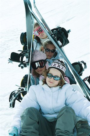 simsearch:649-07520254,k - Young skiers sitting in snow with skis propped up over head, portrait Stock Photo - Premium Royalty-Free, Code: 696-03401673
