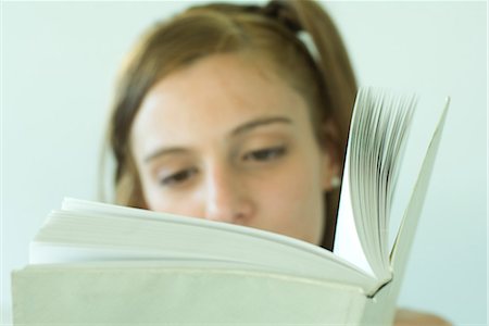 simsearch:632-03083700,k - Young woman reading, focus on book Stock Photo - Premium Royalty-Free, Code: 696-03401725