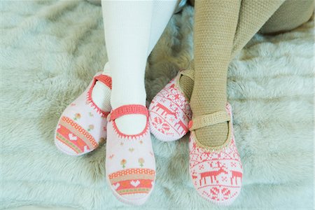 stocking feet - Two teenage girls sitting, wearing tights and slippers, cropped view of feet Stock Photo - Premium Royalty-Free, Code: 696-03401814